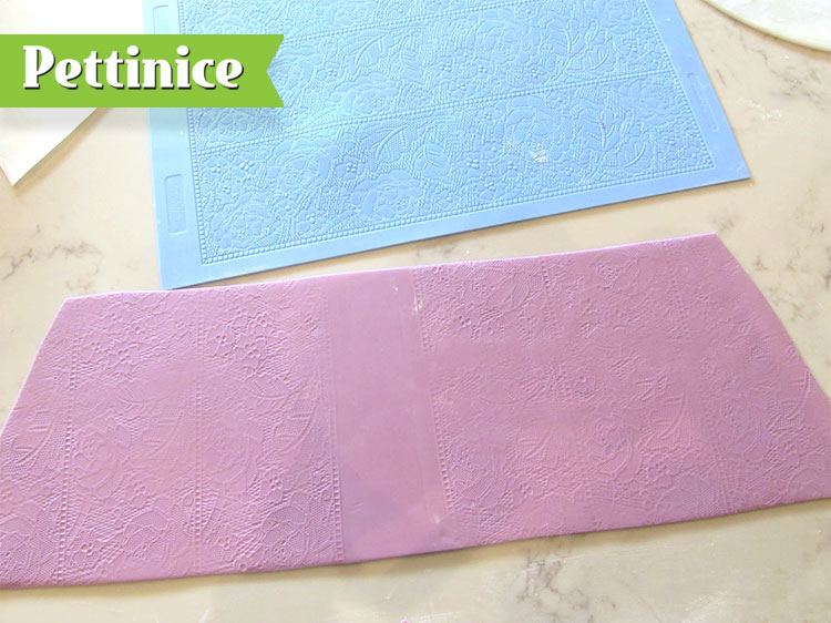 Using your mat, press the lace impression onto the fondant.