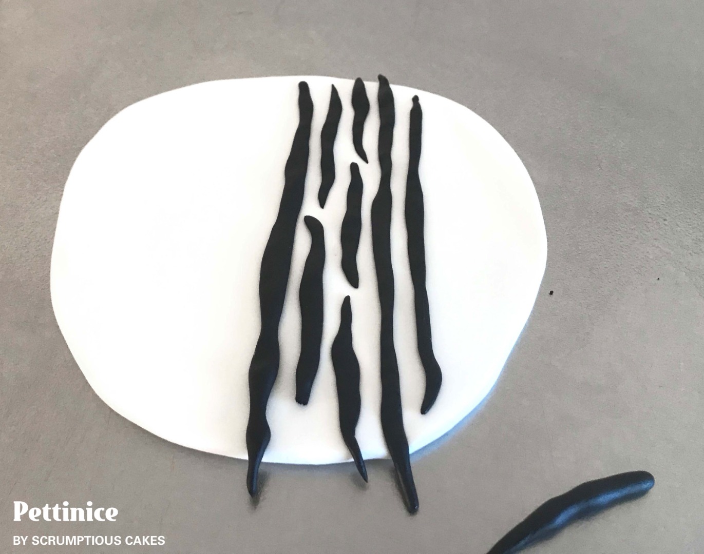 Working quickly so that your icing does not dry out, roll rough ‘sausages’ making sure that there are inconsistencies in length and thickness.