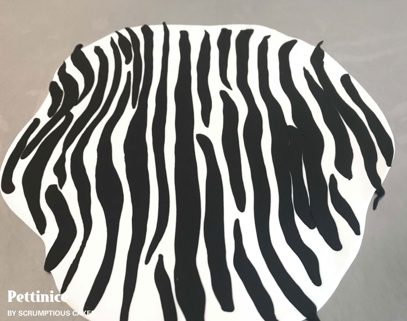 Once you have covered the entire white piece of Pettinice with black sausages as above you can start gently rolling the icing so that it gets to desired thickness for covering your cake which for me is about 3 or 4 mm thick.