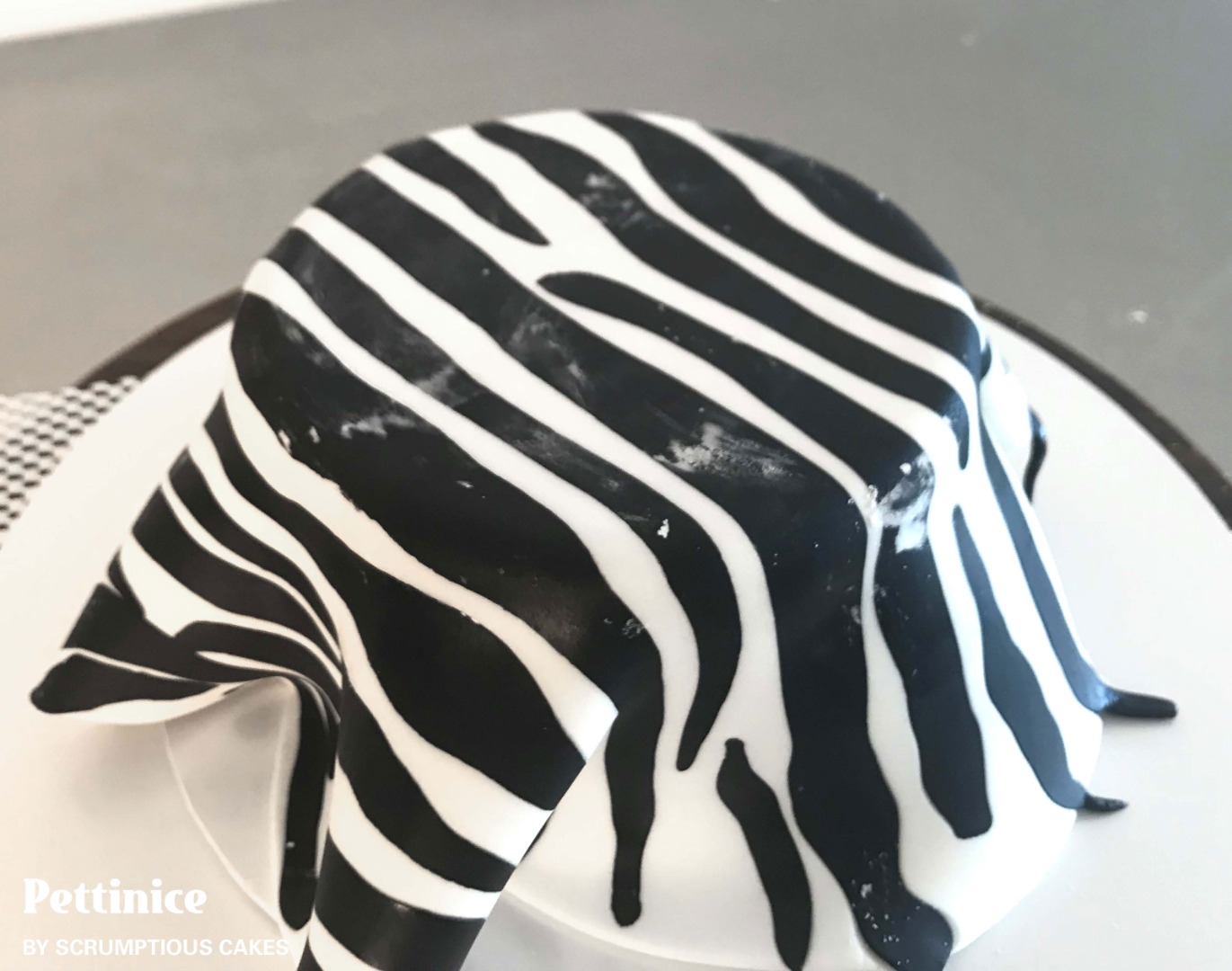 Cover your cake as you would normally, at this stage you can use cornflour.