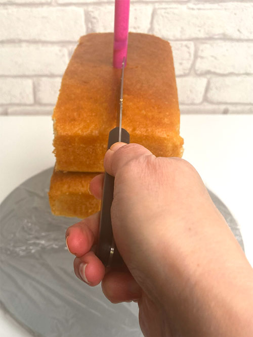 Carve your cake in two halves as it  helps control even shaping