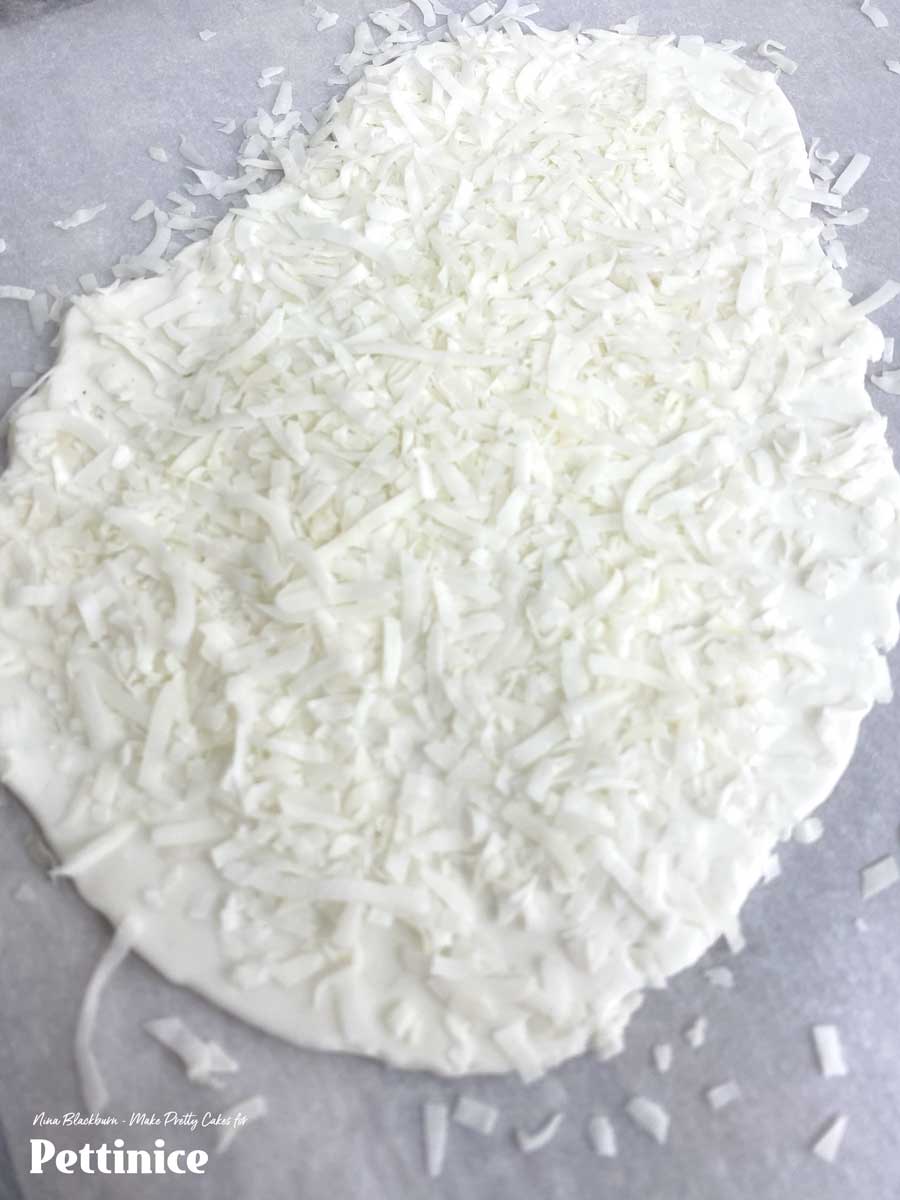 Pour shredded coconut and press down to adhere.  Use your cutter, and this time you may need to help it along with a small knife for cutting.