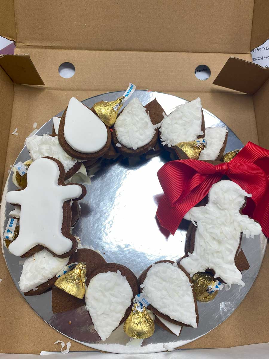 Continue layering and "gluing" the cookies with white chocolate as shown.  Add a bow and remove the centre.  This is a smaller wreath, with 15 cookies.  than the main photo.  Enjoy!
