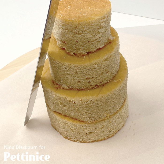 Stack and carve the cakes into a uniform cone shape. Cut in a downwards motion to keep the shape.