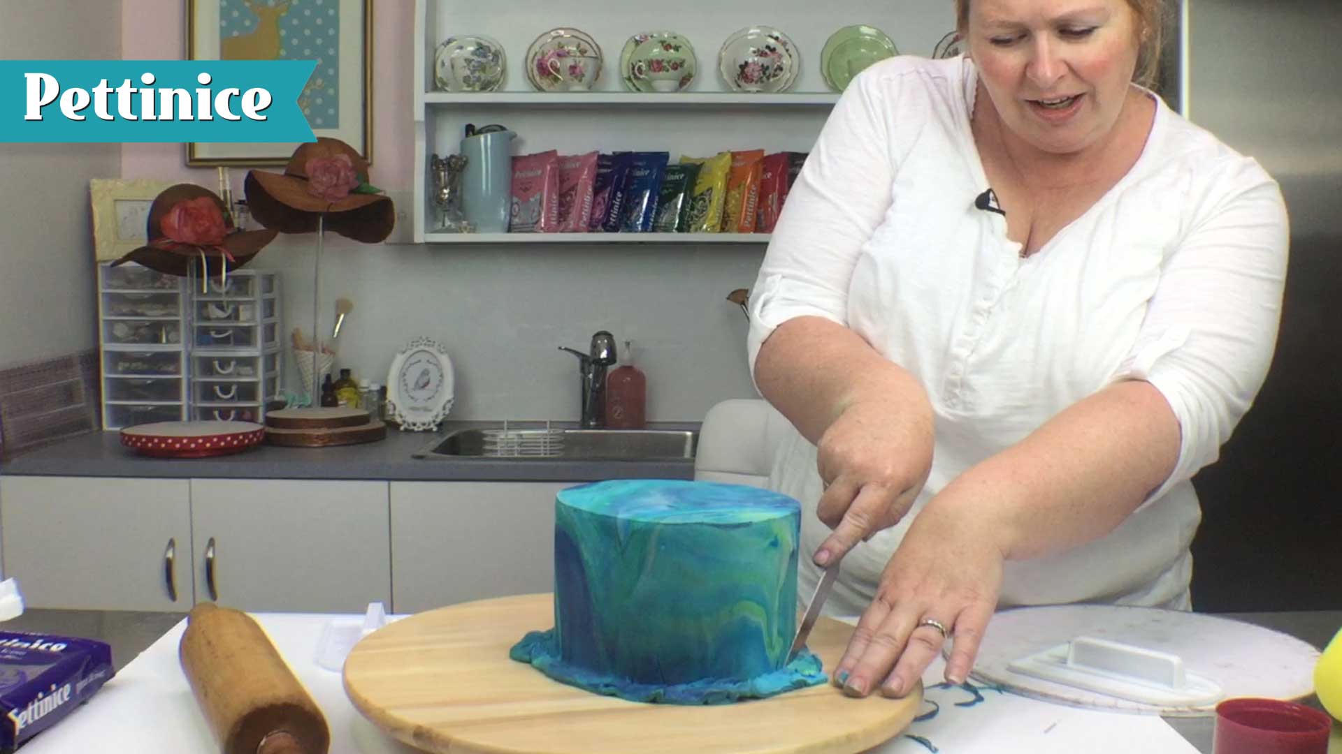 Keeping your knife at a 90 degree angle, trim away excess fondant.
