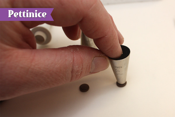 Indent small circles of brown fondant using  the end of a piping nozzle.