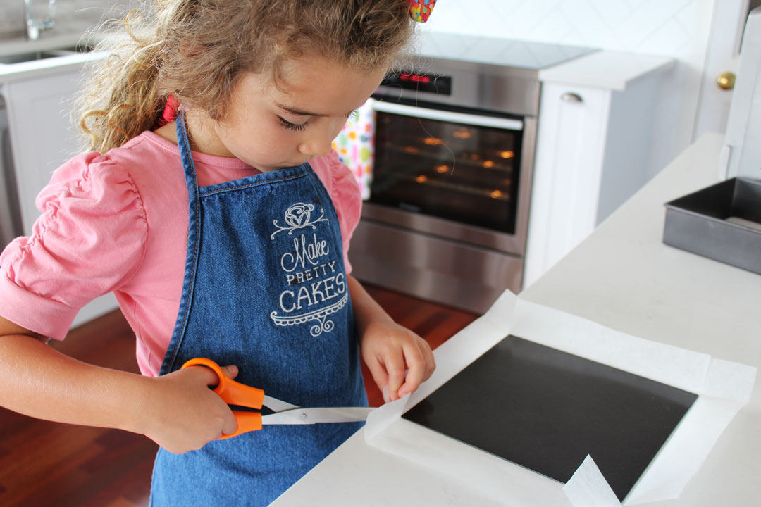 Cut your baking paper larger than your pan like so.  Fold all the edges.