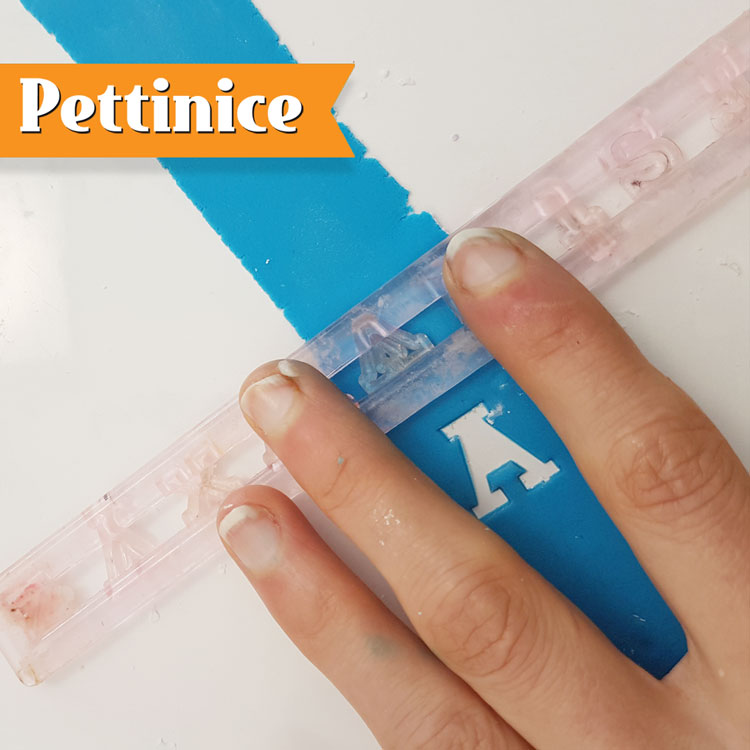 Press your tappit over the strip of fondant. Rub it against the bench to ensure it has cut fully. Then turn it over and rub the letter with your finger to get of any fuzzy edges.