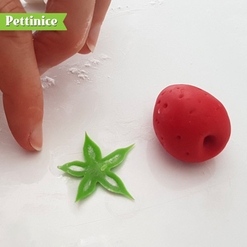 Use your cutter or a blade to cut out a strawberry leaf top. Make sure you clean around the edge with your finger so it cones out tidy.