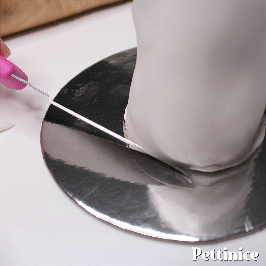 Use a sharp knife to trim excess fondant, and tuck it neatly underneath.