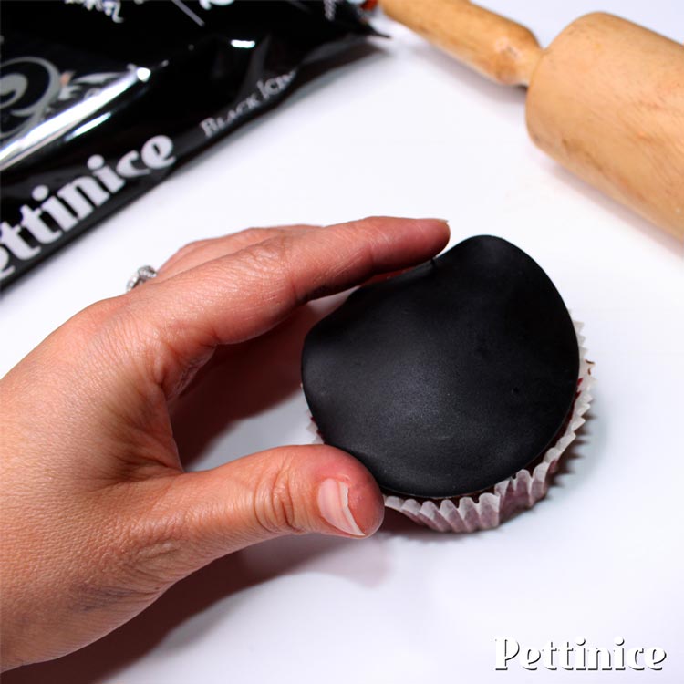 Put a little ganache, buttercream or Bakels Truffle on your cupcake and cover with your fondant disk.