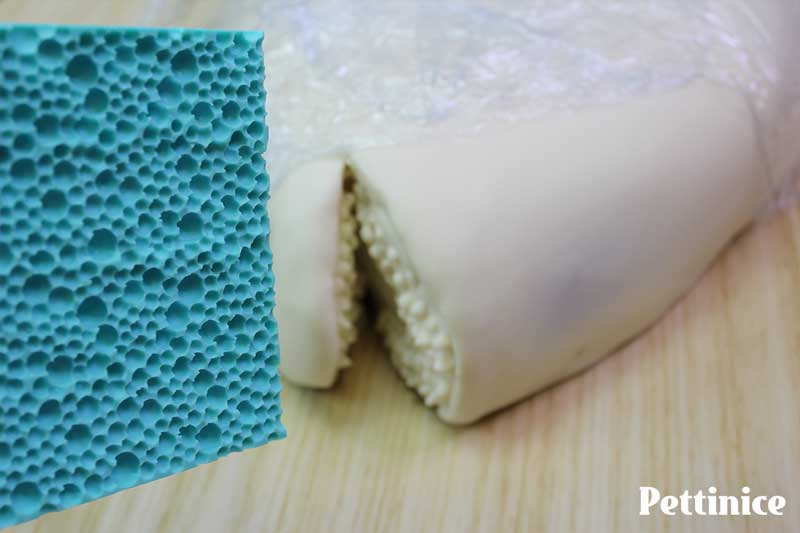 Trim fondant around mouth and smooth edges.  Next, use any embossing texture mat, or crumpled aluminium foil to add texture to the skin.