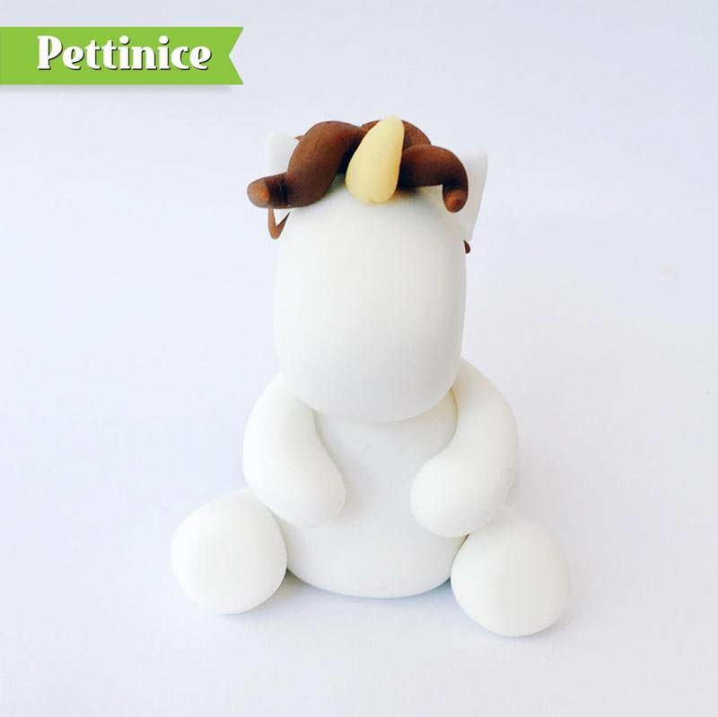 Using a damp brush or edible glue, stick the mane in place. You can add optional unicorn horn to the front!