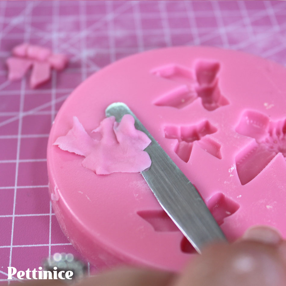 After pushing your fondant into the mold, use a small sharp blade to remove the excess.
