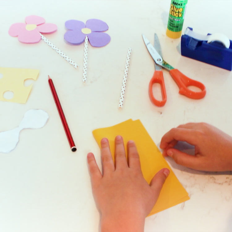 Fold your paper in half.  You can make a few flowers at a time too.