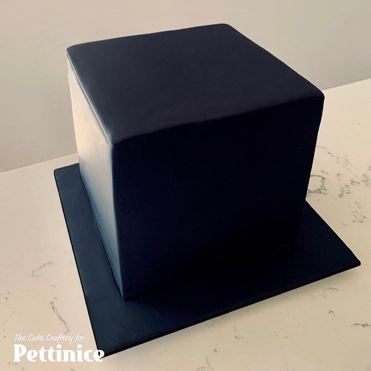 Cover your cake and board in Pettinice. I used black. This cake is a 14 cm x 14 cm x 14 cm cube.
