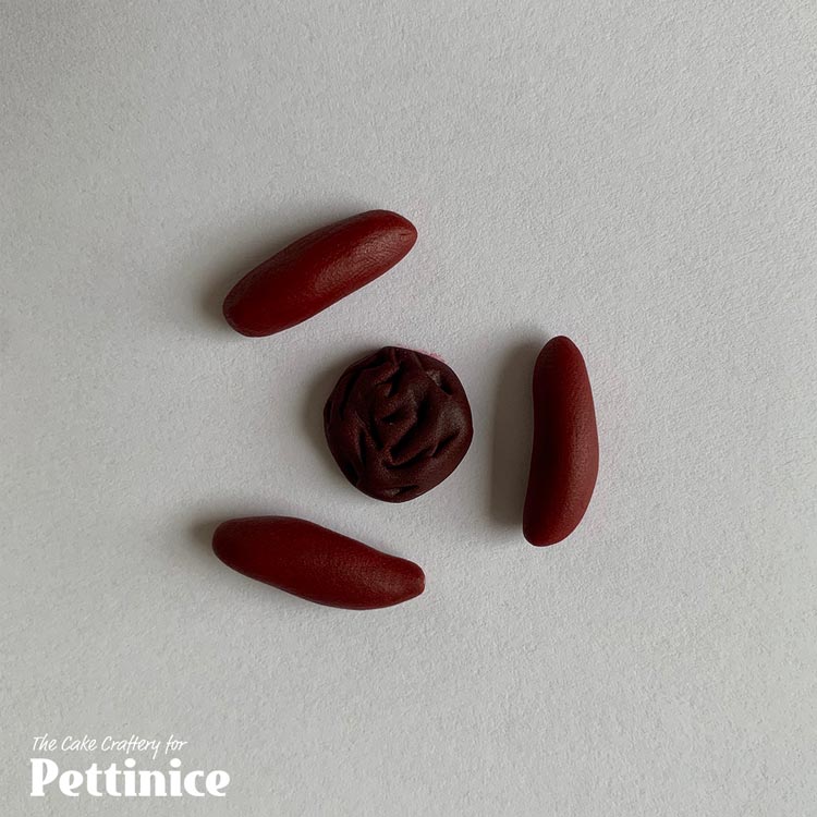Make 3 x 1cm (0.5g/pea-sized) sausage shapes out of dark ruby red.