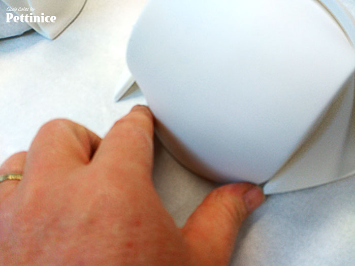 Press the back of the nurse's hat into the half round to secure it in place.