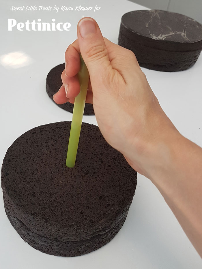 Core the centre of your cakes with your large straw. This will make it easier to line up and lift over structure at the end.