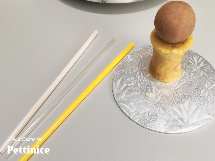 Cover bottle "neck" with white Pettinice.  You will later use a straw to anchor this to the main body of the cake.  To make it easier, first "drill" a hole through the pieces with your straw to prevent misshaping when assembling.