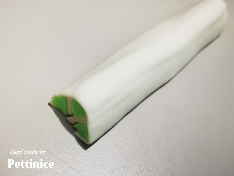 Once glued, flip and roll into a half circular tube like so.  Press and smooth to secure.  Roll out a thin green layer and glue on top for the lime peel.