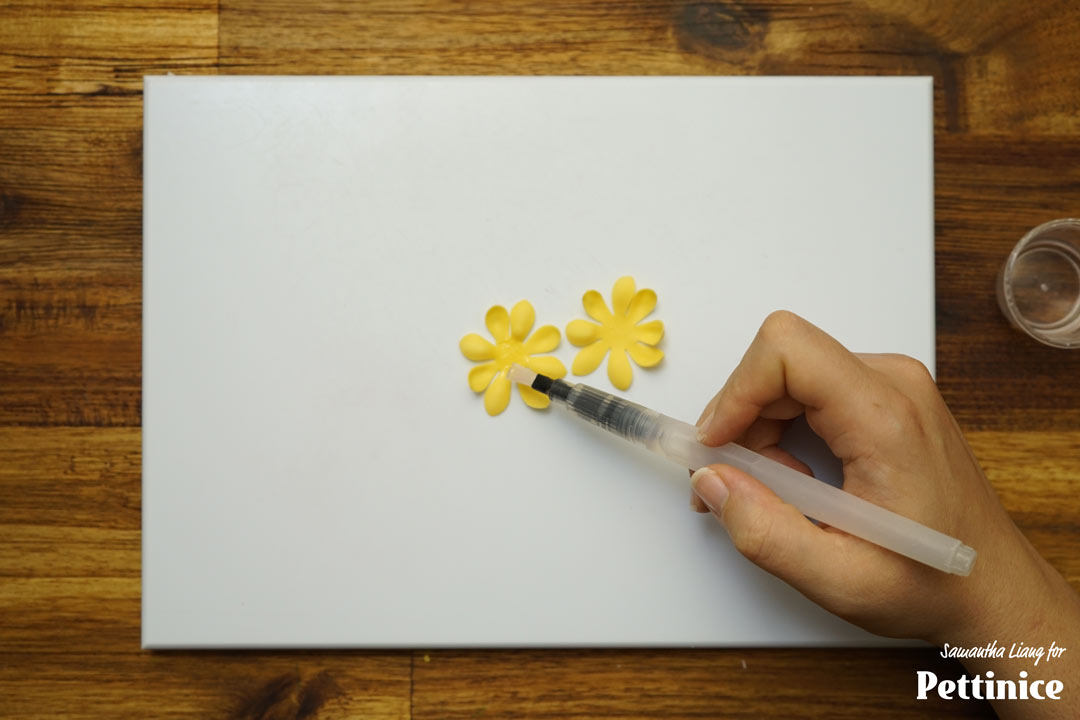 Place a tiny dab of glue in the centre of one set of petals and stick the second set on top. Make sure the petals are not overlapping completely.