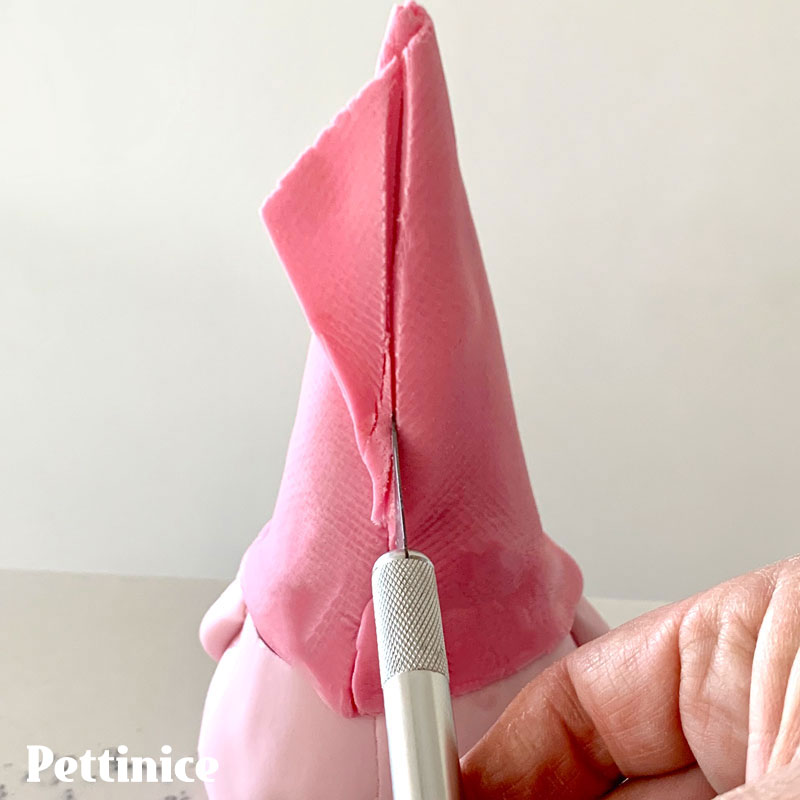 36. Gently smooth against the cone and cut off the excess neatly at the back with your blade or craft knife. You can trim the point straight or have a little bend in it.