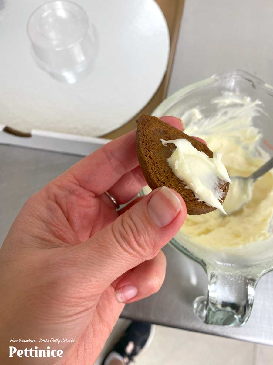 If you want to gift your wreath, and not set it on a party table, you can glue it to a cake board using chocolate. Melt white chocolate and spoon a small amount on the bottom of the wreath to stick in place.